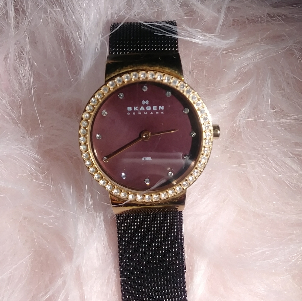 Skagen ladies black and gold watch.